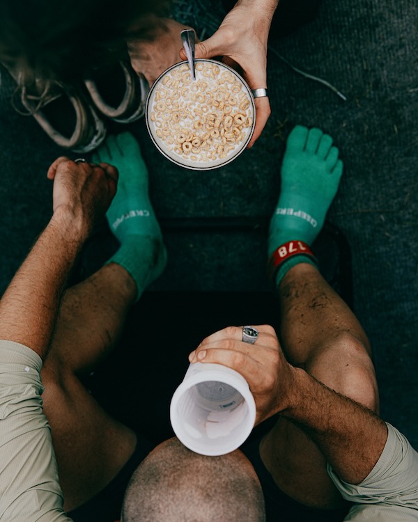 Athlete eating between loops at a backyard ultra