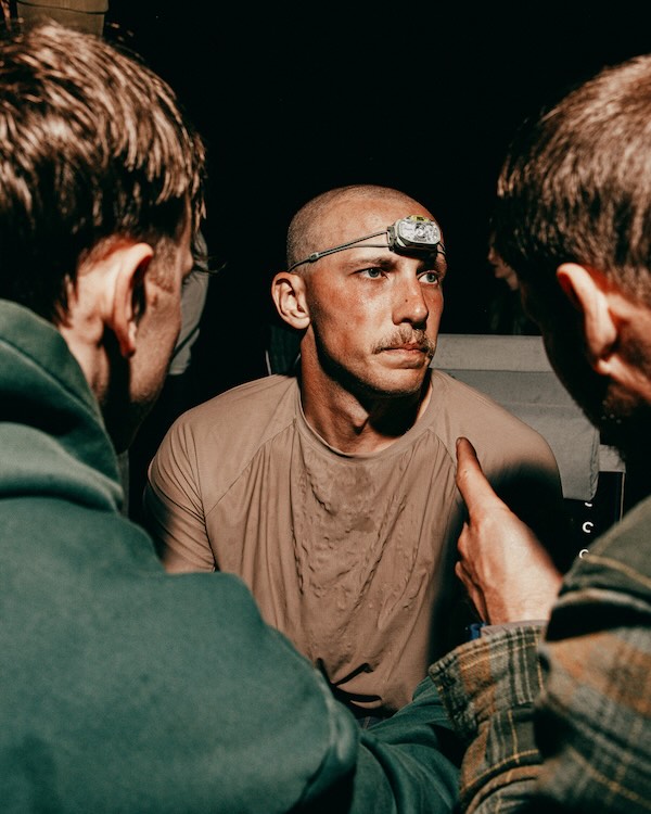 Crew member directing an athlete at the transition area during a backyard ultra