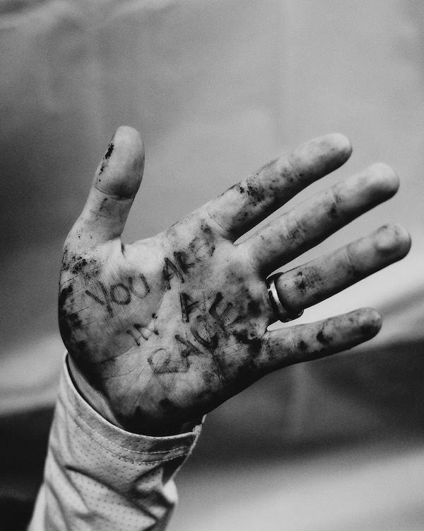 Hand with 'you are in a race' written on the palm
