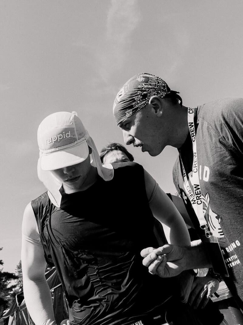 A crew member checking in with a runner between loops at a backyard ultra